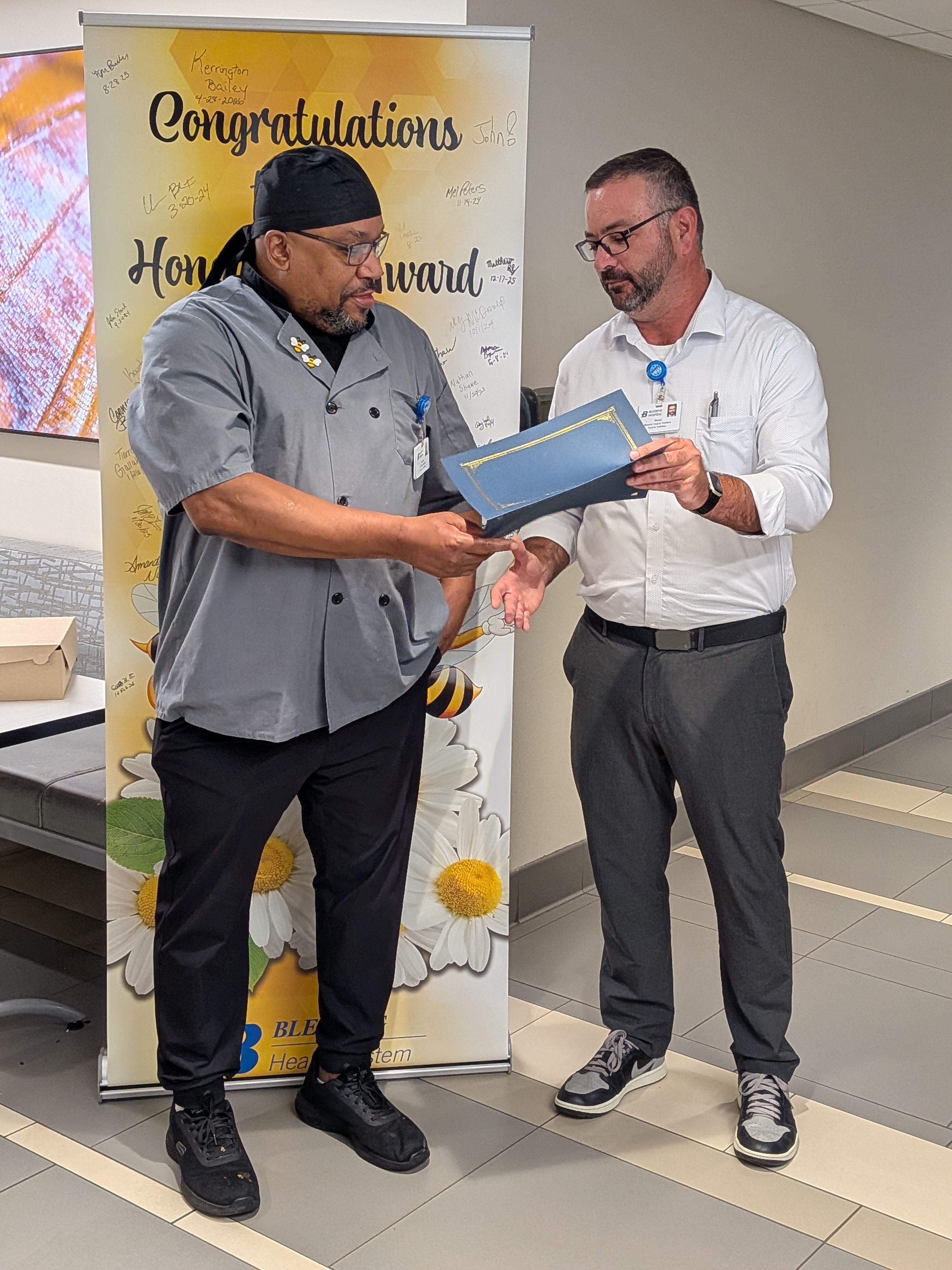 Darrick Mayfield receives the Honey Bee award from Blessing Health System