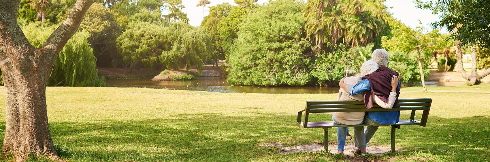 senior couple sitting in park