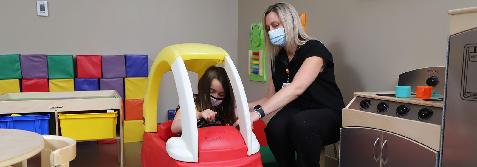 nurse talking with pediatric patient