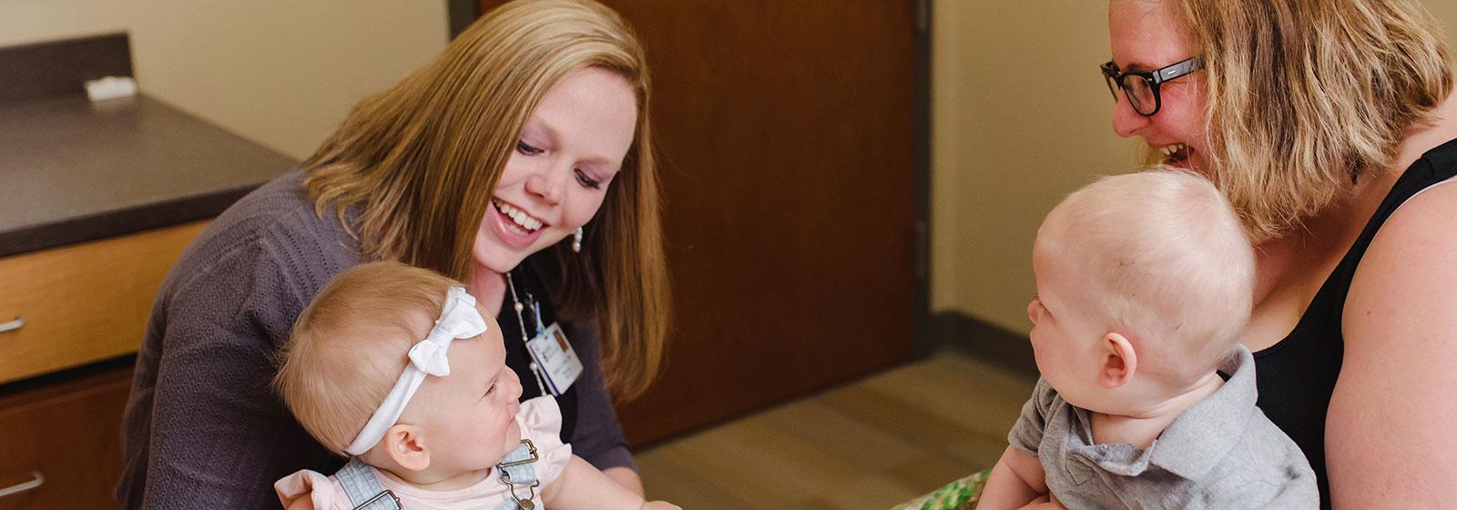 Dr. Curry talking with mom and babies