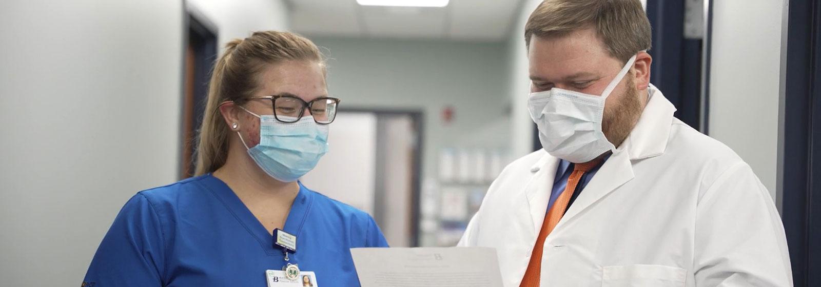 Dr. Holland talking with nurse